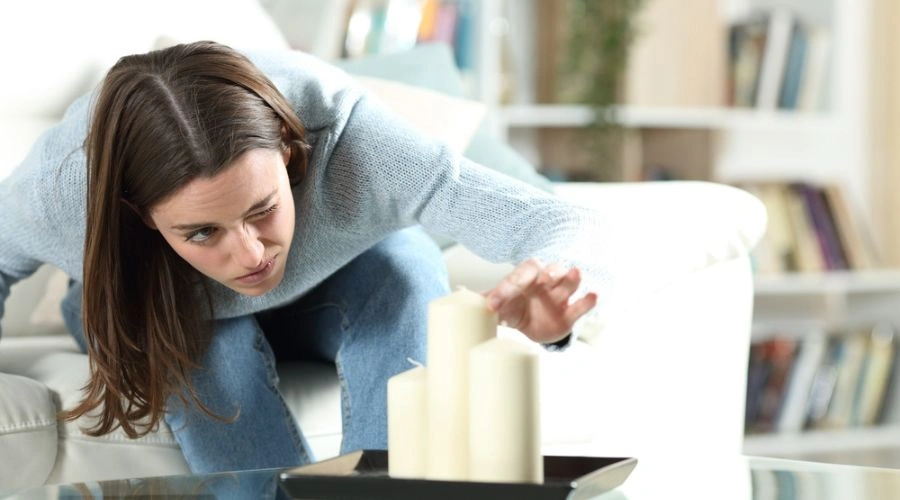 Common Signs a Teen Is Struggling with OCD: Image of teen placing candles on a table - Artemis Adolescent Healing Center