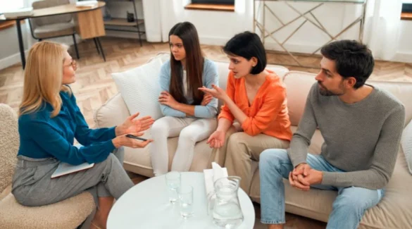 Image of a mother, father and daughter talking a female therapist - Family Therapy for Teens in Recovery at Artemis