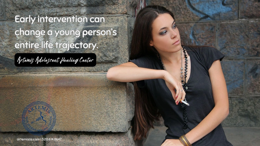 Image of a female teen standing with a cigarette in one hand - Early Intervention can change a young person’s entire life.