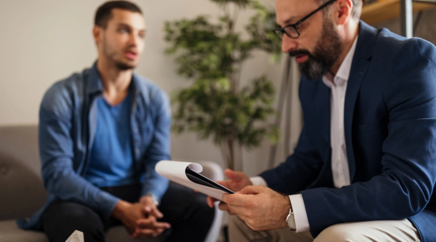 Image of a male teen in a residential treatment facility talking to a counselor and receiving care for Xanax addiction