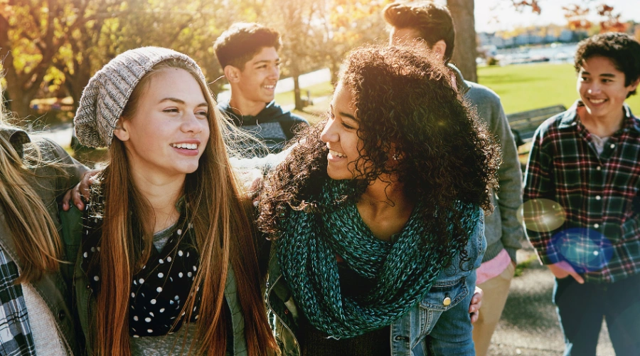 Image of teens gathered together smiling and content - What Is Teen Mental Health First Aid - Artemis Adolescent Healing Center
