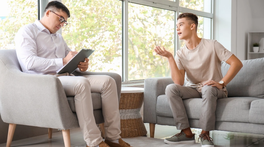 Image of teen in therapy session practicing collaboration, evocation, and autonomy with a counselor