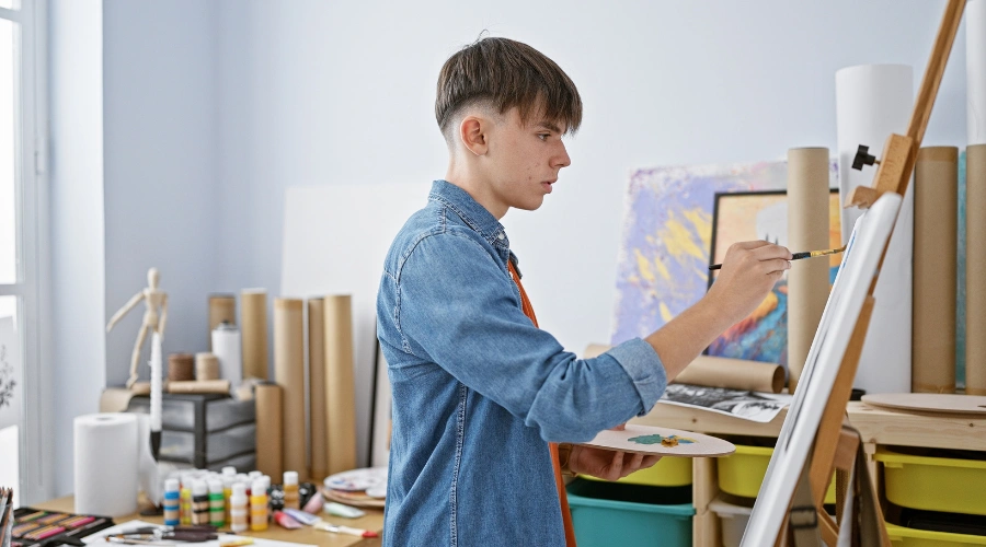 Image of teen painting as part of holistic therapy, symbolizing creativity and emotional healing in schizotypal personality disorder treatment