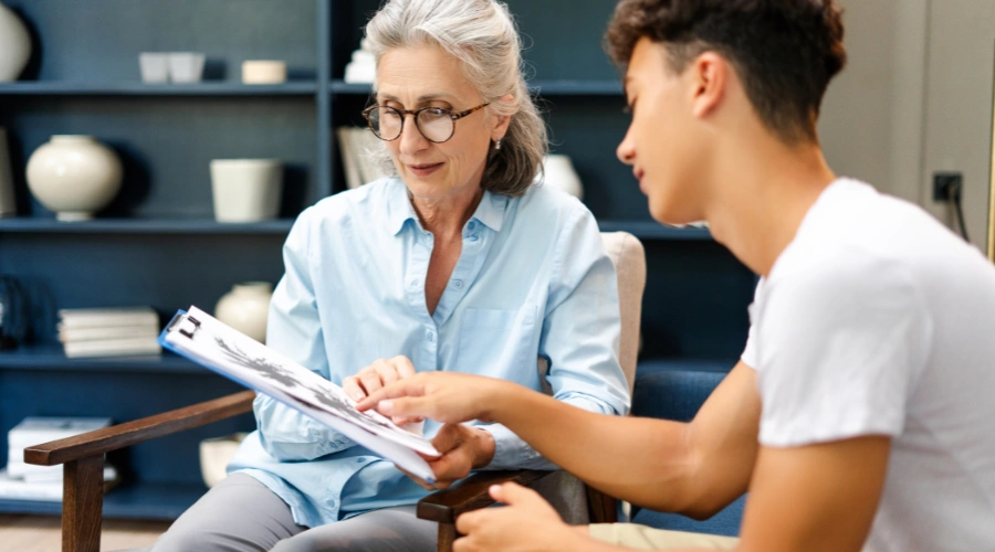 Image of a certified therapist reviewing treatment credentials to ensure safe and effective teen mental health care
