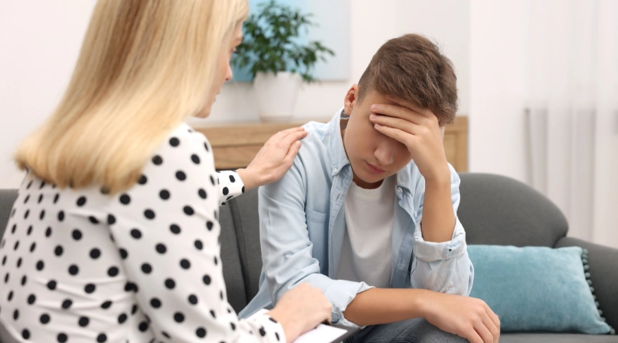 Image of a compassionate therapist talking with a teen in a calm, supportive environment, symbolizing hope and recovery from self-harm