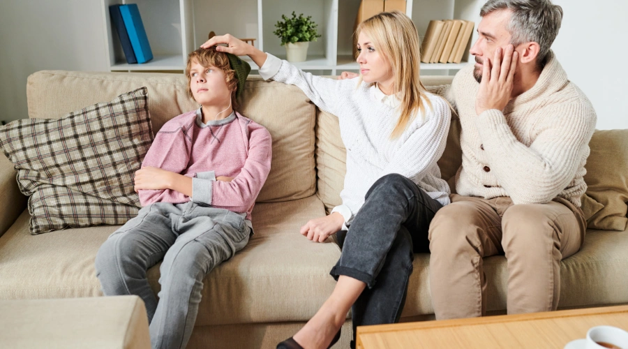 Image of a worried parent talking gently with their teen , symbolizing a discussion about self-harm and emotional pain
