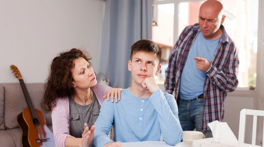 Image of a mother encouraging her teen son with depression, using positive reinforcement at home