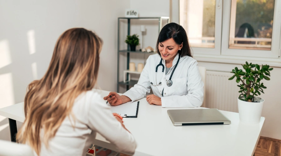 Image of a medical professional discussing a teen patient with a parent - Does Optum Cover Teen Rehab - Artemis Adolescent Healing Center