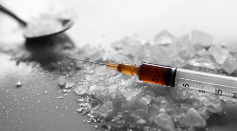 Image of a syringe and needle on top of meth crystals - How Many Teens Use Meth - Artemis Adolescent Healing Center