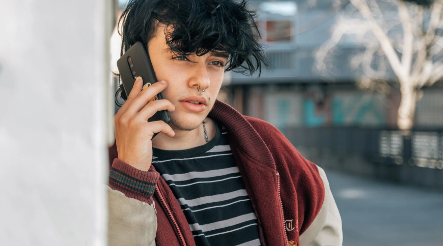 Image of a teen reaching out for help by calling a crisis hotline