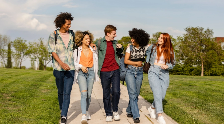 Image of a a group of teenagers walking away from their school grounds