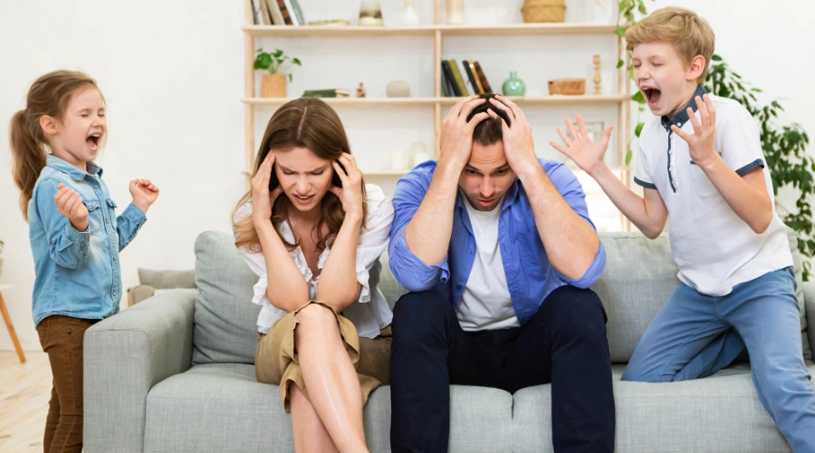 Image of calm parents while Adolescent shouts during an aggressive emotional outburst at home