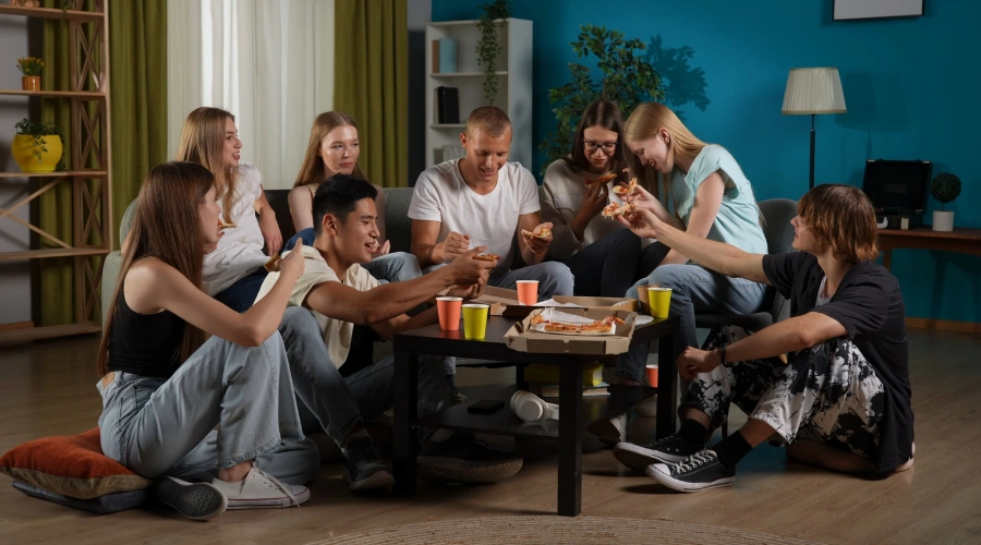 Group of teenagers socializing at a party, representing teen alcohol use and slang parents should recognize