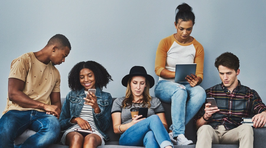 Teen group texting and socializing, representing teen drug slang and substance use awareness for parents