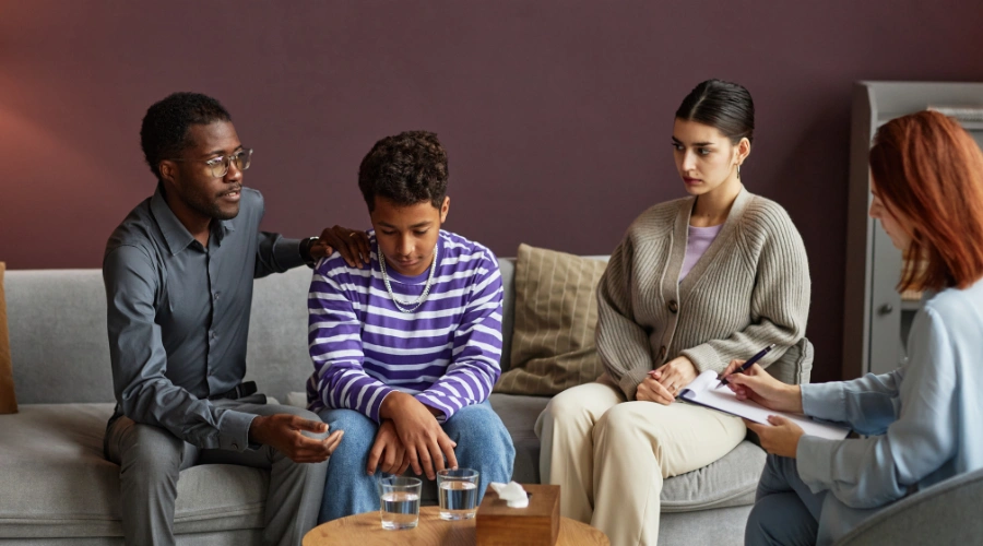Image of a family participating in therapy sessions to address oppositional defiant disorder in their teenager