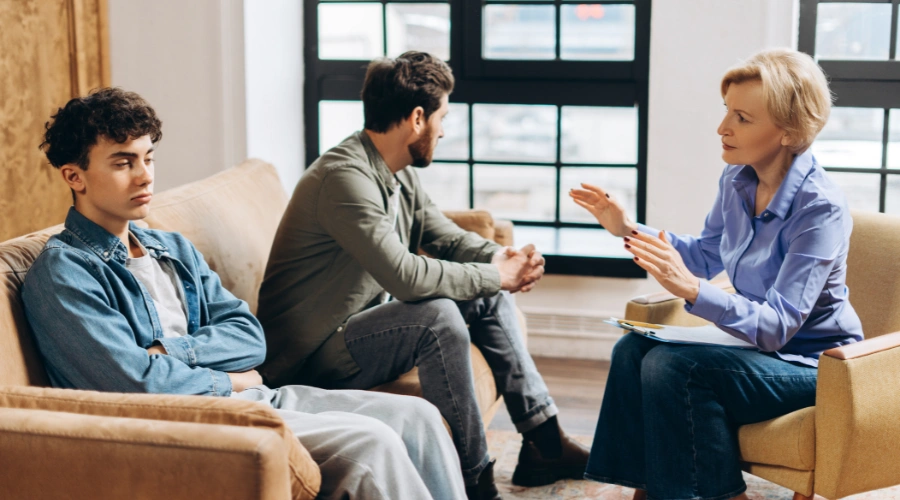 Image of a teenager and therapist reviewing the elements of a comprehensive addiction treatment plan