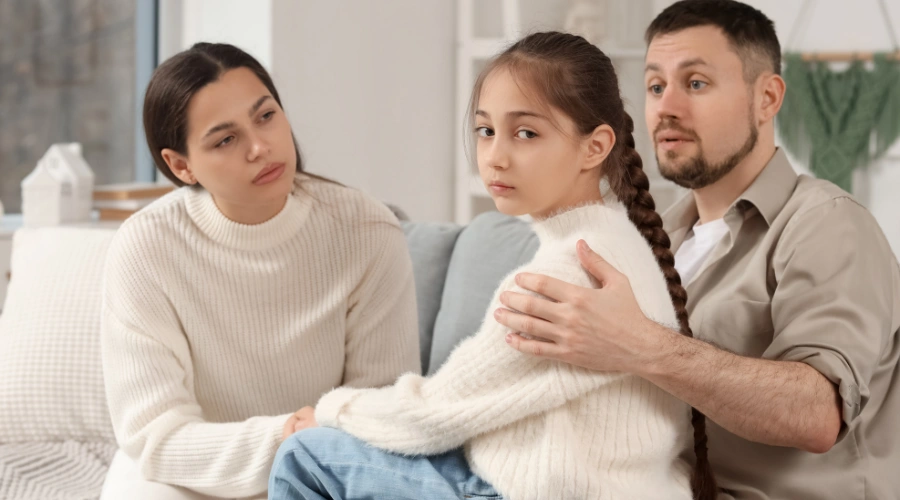 Image of a concerned parent observing their withdrawn teenager representing the warning signs