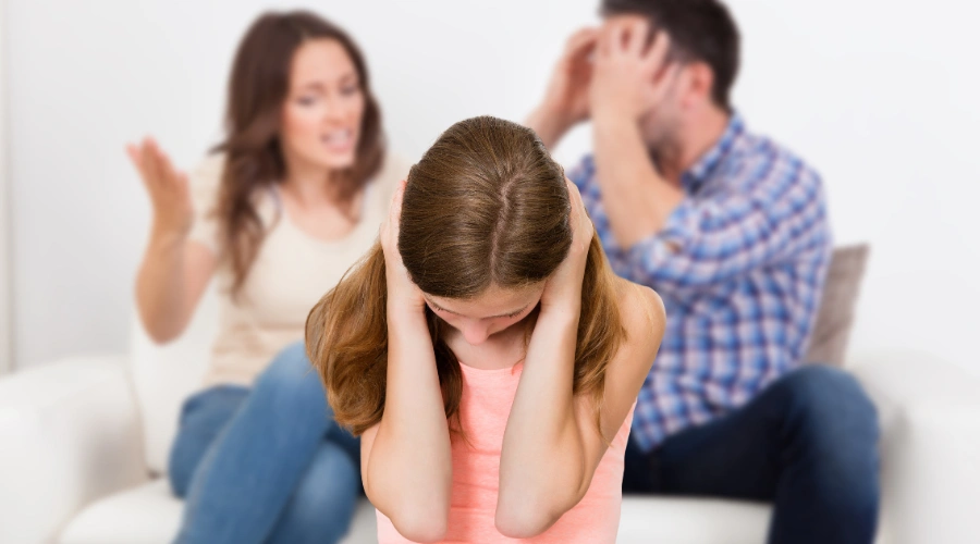 Image of a teenage girl covering her ears while parents argue in the background