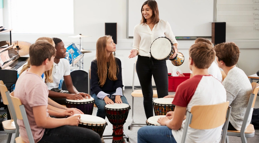 Image of a group of teenagers playing musical instruments together during a therapy session